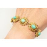 9ct gold turquoise bracelet, worked with nine beaded flowerhead style links (15mm x 18mm),