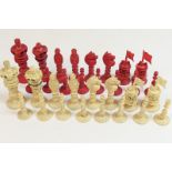 Anglo-Chinese carved and stained ivory chess set, late 19th Century, the kings 9.5cm, the pawns 5.