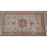 Tabriz woollen rug, fawn field centred with a russet foliate medallion against a russet border,