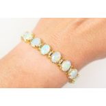 Attractive opal and diamond line bracelet, having 19 well matched cabochon opals, each of approx.