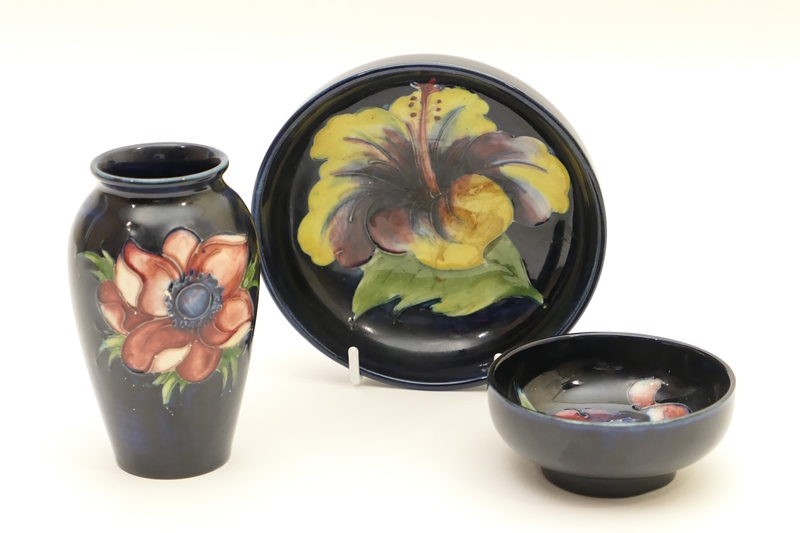 Moorcroft anemone small vase, decorated with flowers against a deep blue ground, impressed marks,