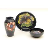 Moorcroft anemone small vase, decorated with flowers against a deep blue ground, impressed marks,