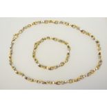 18ct white and yellow gold suite by Boodle and Dunthorne comprising necklace and bracelet,