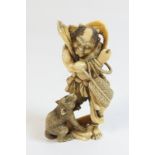 Japanese carved ivory okimono, Meiji (1868-1912), carved as an Oni with a Baboon,