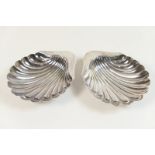 Pair of George V silver scallop butter dishes, Sheffield 1920, on ball feet, 12cm, weight approx.