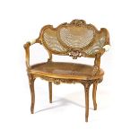 French walnut and parcel gilt bergere fauteuil,