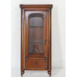 Mahogany glazed hanging cupboard, having a moulded cornice over a single arched glazed panel door,