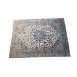 Kashan woollen carpet, fawn field with a central sage green palmette medallion,