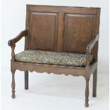 Small oak settle, late 19th Century, double fielded panel back, open arms,