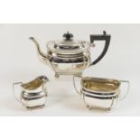 George V silver bachelor's three piece tea service, Birmingham 1922, comprising teapot,