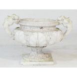 Victorian painted terracotta urn, moulded with dolphin handles and water lilies, over a square base,