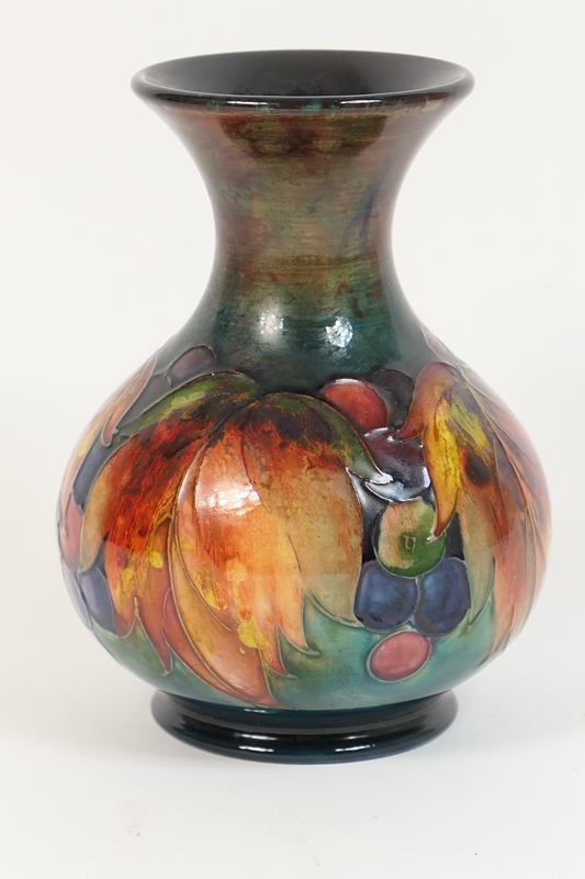 Moorcroft leaves and berries vase, baluster form with trumpet neck,