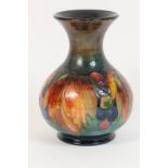 Moorcroft leaves and berries vase, baluster form with trumpet neck,