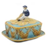 George Jones majolica sardine dish and cover, moulded on the cover with a boy mending fishing nets,