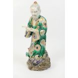 Japanese Kutani figure of a scholar, late 19th Century, decorated in green robes with gilt details,