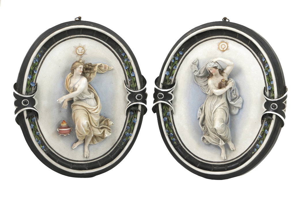 Pair of French coloured bisque wall plaques, modelled figuratively as Day and Night,