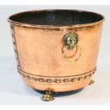 Late Victorian copper log bin, with lion's mask ring handles, riveted details raised on paw feet,