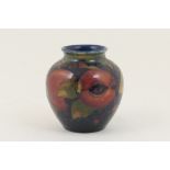 Moorcroft Pomegranate small vase, inverted baluster form with deep blue ground,