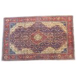 Kashan woollen rug, deep blue field with a central red pole medallion,