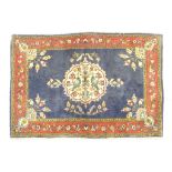 Kerman woollen small rug, blue field with central fawn medallion detailed with birds,