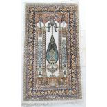 Pakistani silk prayer rug, having a central ivory field with flowering vases within the mihrab,