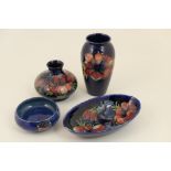 Four pieces of Moorcroft in the Anemone pattern comprising: ovoid vase, blue ground,