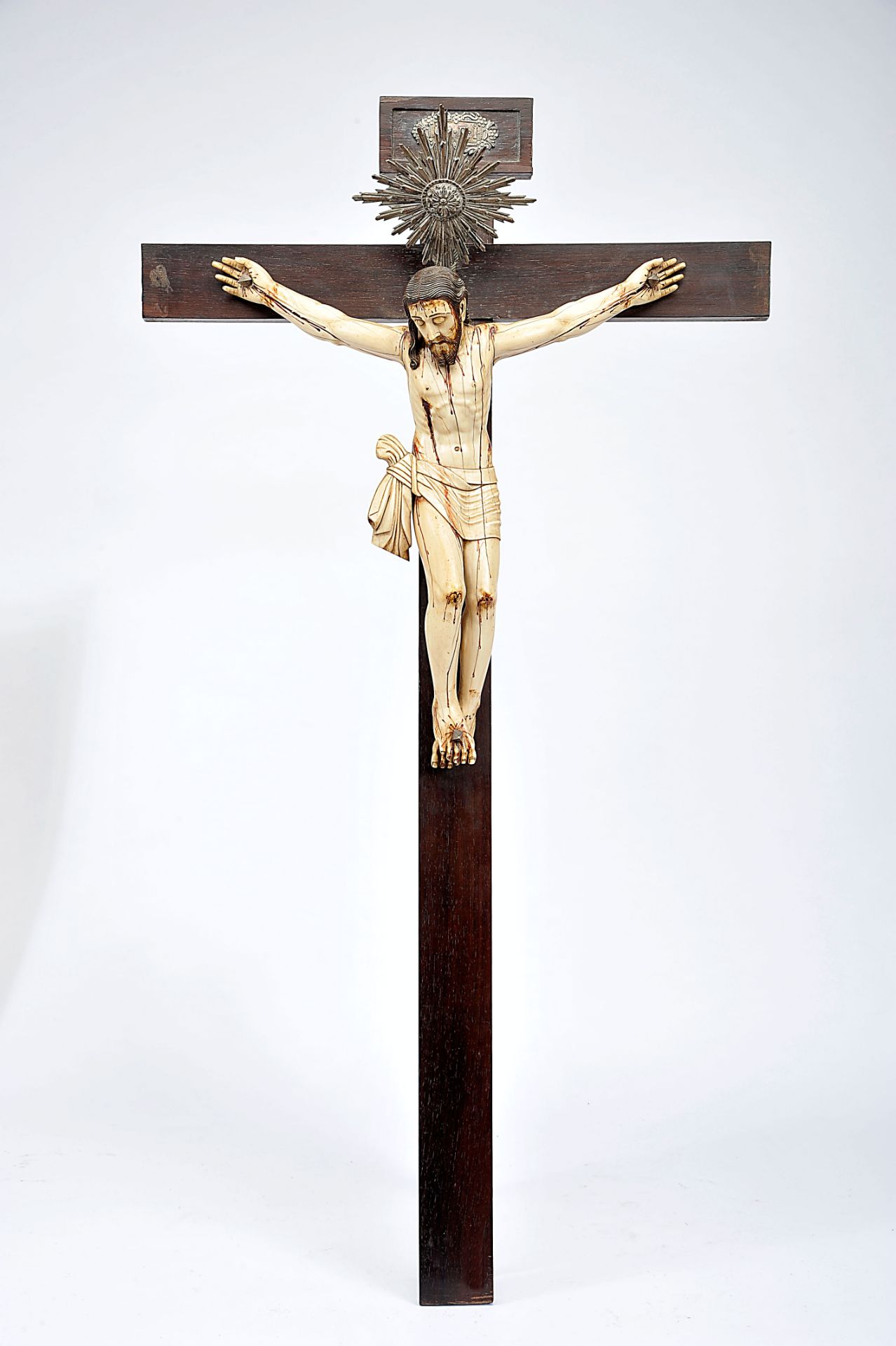 Crucified Christ, partly painted ivory sculpture,, Brazilian rosewood cross with silver halo and "
