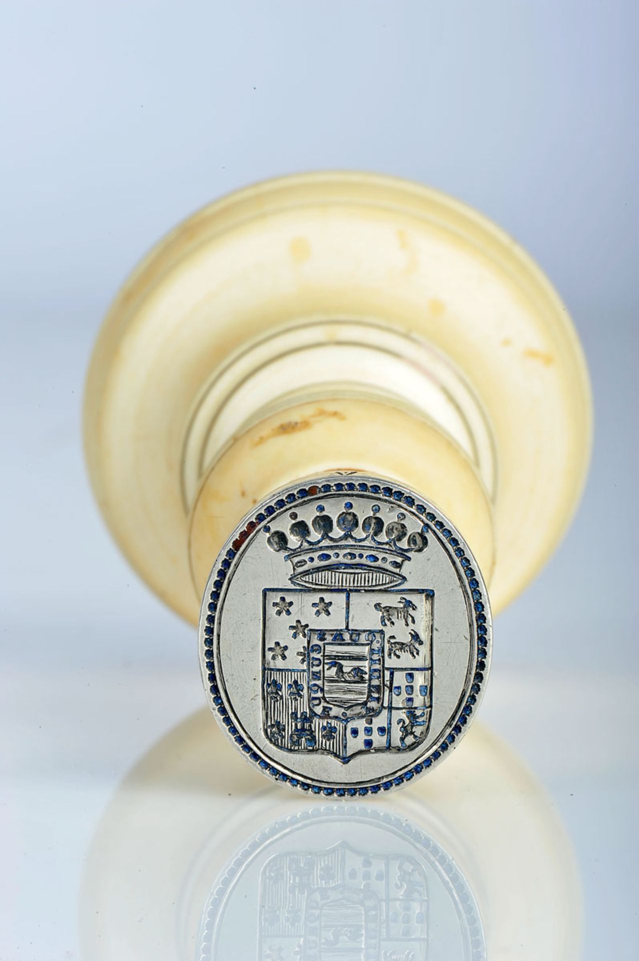 A Signet, turned ivory handle, silver handle engraved with the coat of arms of a Portuguese family -