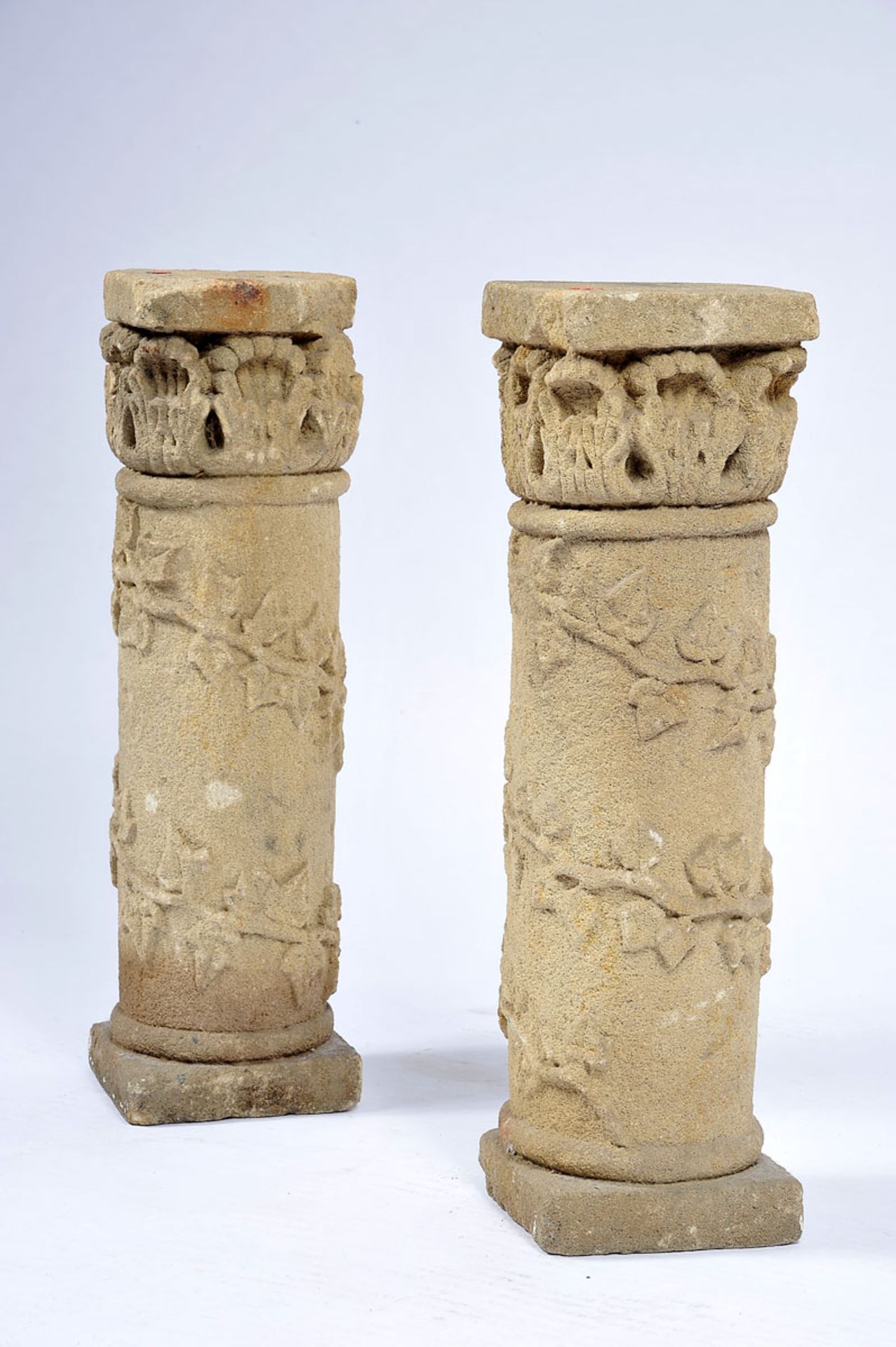 A Pair of Low Columns, carved granite, capitals en relief "Acanthus leaves", Portuguese, faults,