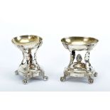 A Pair of Salt and Pepper Cellars, 833/1000 silver, decoration en relief "Grotesque masks, pine