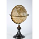 A Globe, wood lined witn an engraving, embossed bronze rings with measurements, ebonised wooden foot