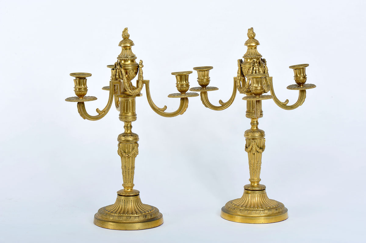 A Pair of Three-fire Candelabra, Louis XVI style, gilt bronze en relief, French, 19th C., wear to