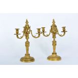 A Pair of Three-fire Candelabra, Louis XVI style, gilt bronze en relief, French, 19th C., wear to