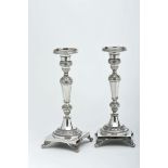 A Pair of Square Base Candlesticks, 833/1000 silver, engraved decoration, zoomorphic feet,