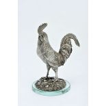 A Rooster, silver sculpture, chiselled decoration, Portuguese, 19th/20th C., later glass base, no