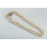 A Necklace, a string of freshwater pearls (7 mm), 800/1000 white gold clasp, set with 28 8/8 cut