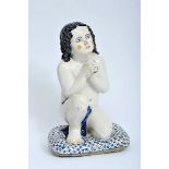 Boy kneeling on a cushion, faience sculpture, polychrome decoration, Portuguese, 19th C. (1st half),