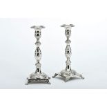 A Pair of Square Base Candlesticks, 833/1000 silver, engraved deoration en relief "Flowers", feet en