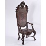 A High Backrest Armchair, carved walnut, embossed leather seat and back with studs and a