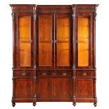 A Cupboard, romantic, mahogany and burr-mahogany veneer, columns with carved capitels and bases,