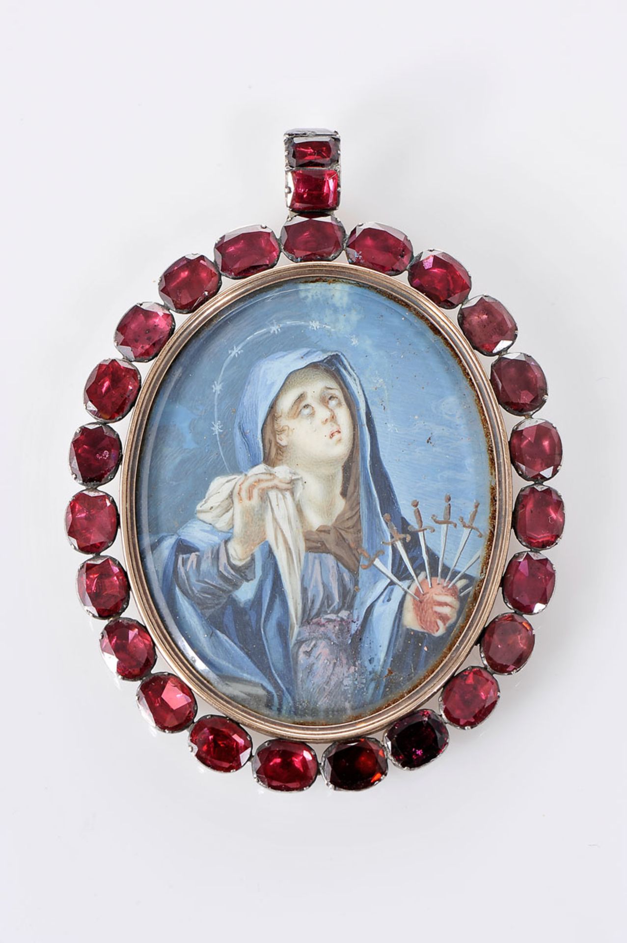 A Pendant "Our Lady of Sorrows", silver, frame set with garnets, Iberian, 19th/20th C., moisture