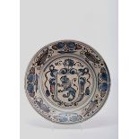 A Dish, faience, blue and vinous "spiders" decoration with the coat of arms traditionally attributed