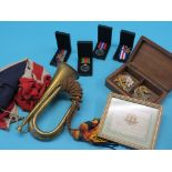 Militaria, including cap badges, brass bugle, four medals, etc.