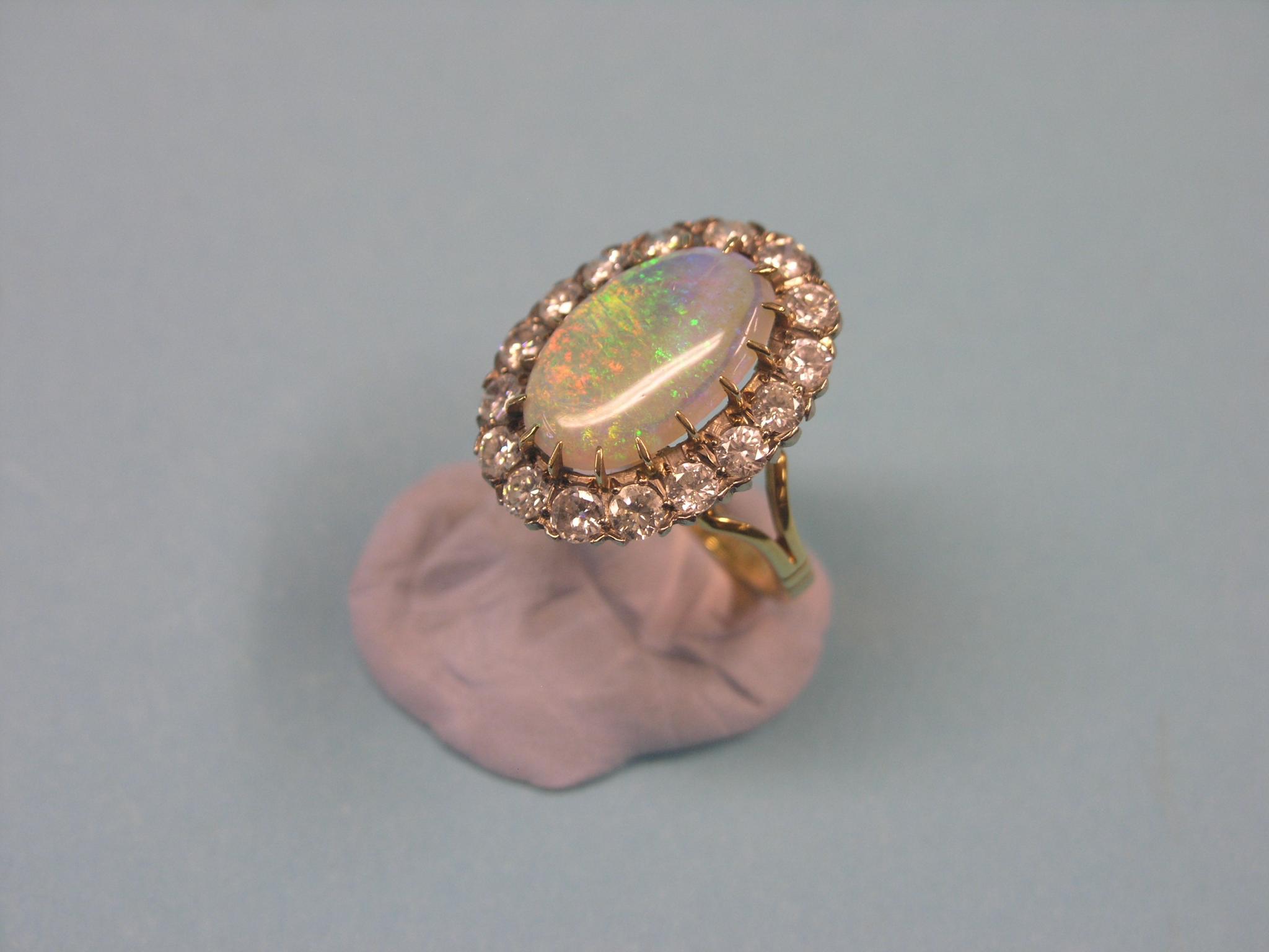 A large 18ct. gold black opal and diamond dress ring, central oval opal surrounded by sixteen claw- - Bild 2 aus 2