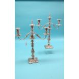 A large pair of silver plated candelabra, each with three scroll branches, 18in.