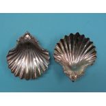 A pair of late George II silver shell dishes, with cast rococo handles, each on three nautilus shell