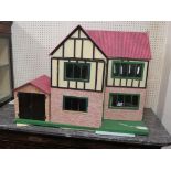 A Tri-Ang doll's house, timber-framed with printed pantile roof and brickwork, four part-furnished