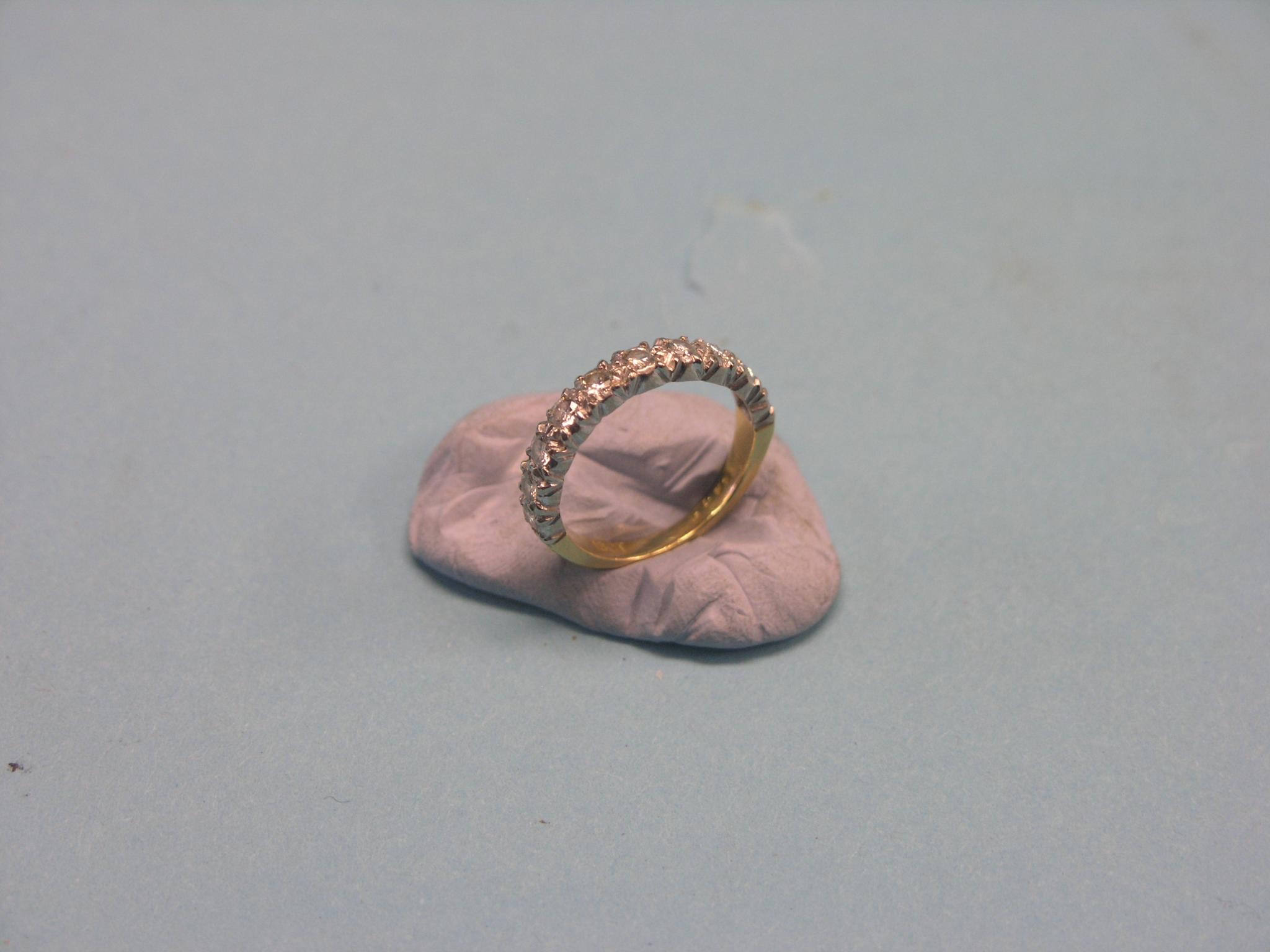 An 18ct. gold diamond half-eternity ring, size J