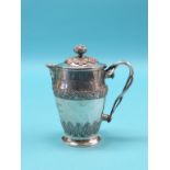 An early 19th century silver pitcher, bulbous form with hinged cover, entwined branch handle, body