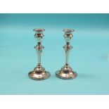 A pair of silver candlesticks, tapering stems and circular, loaded bases, Birmingham 1912, 8in.